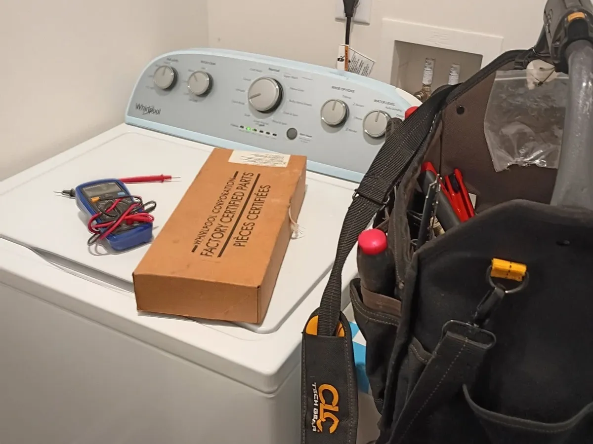 Washing machine repair near me - Decatur Solution Works technician repairing a Whirlpool top-load washer with factory-certified parts in Decatur GA